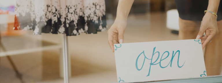 hands holding an open sign